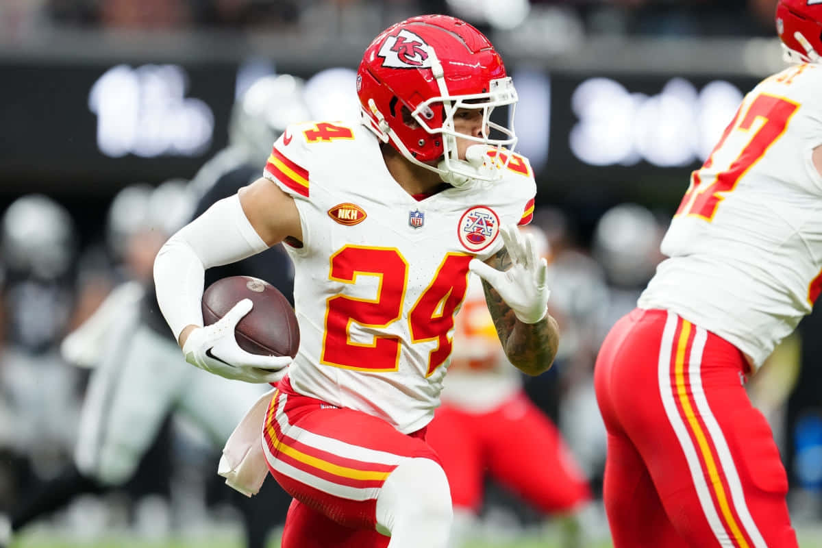 Chiefs_ Player_ Running_ With_ Football Wallpaper