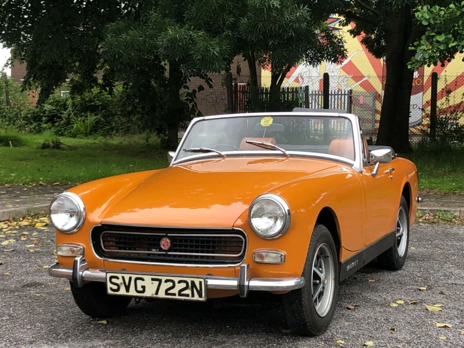 Classic Beauty – A Stunning Mg Midget On The Road Wallpaper