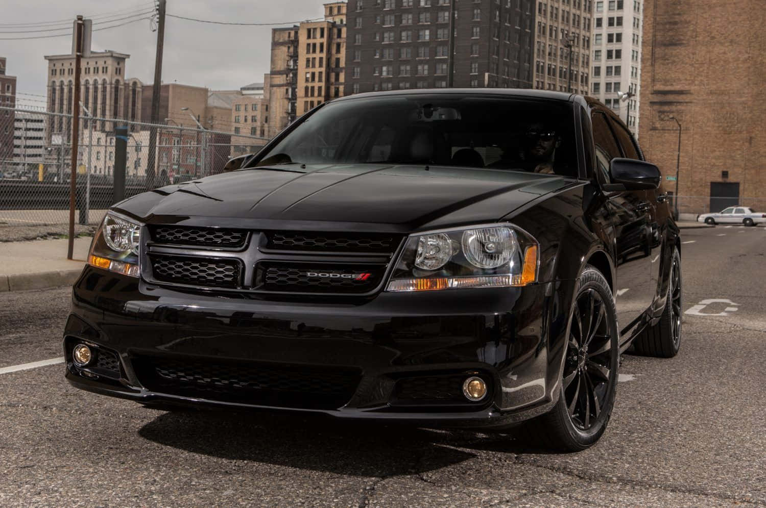 Classic Dodge Avenger Speeding On A Mountain Road Wallpaper