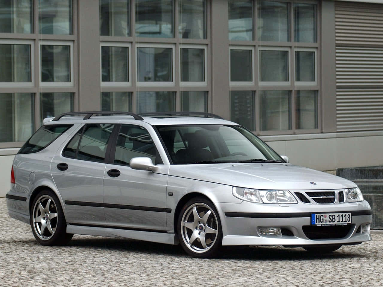 Classic Saab 9-5 Cruising Down The Highway Wallpaper