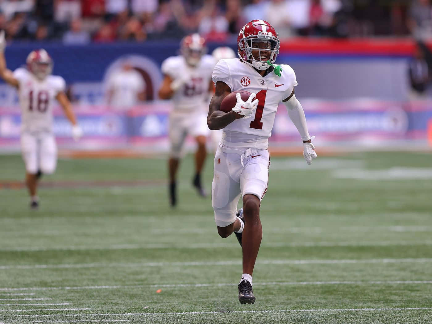 College Football Player Running With Ball Wallpaper