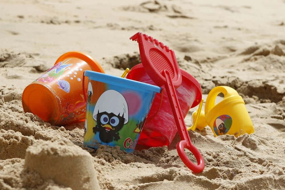 Colorful Beach Toys On The Sand Wallpaper