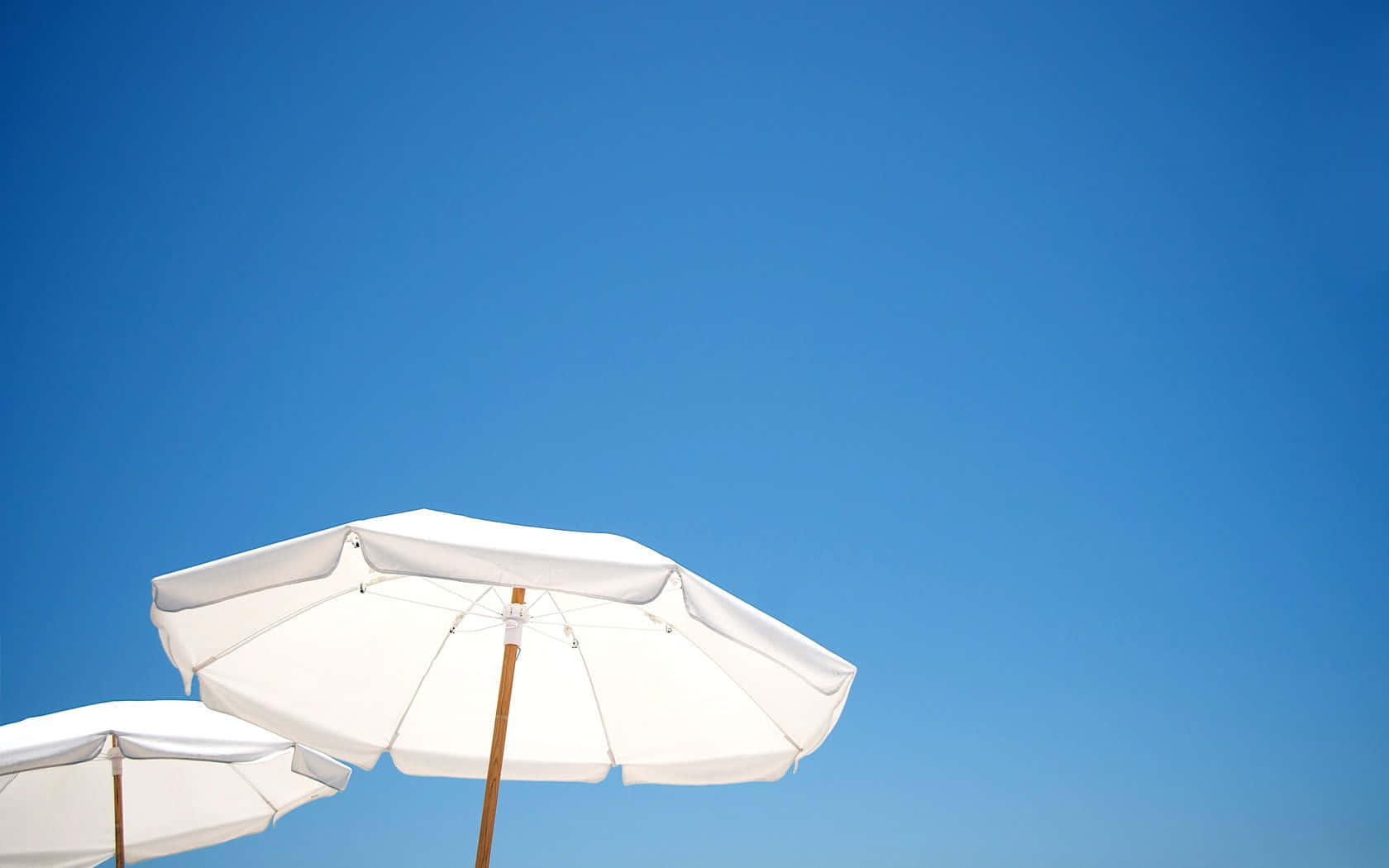 Colorful Beach Umbrella By The Seashore Wallpaper