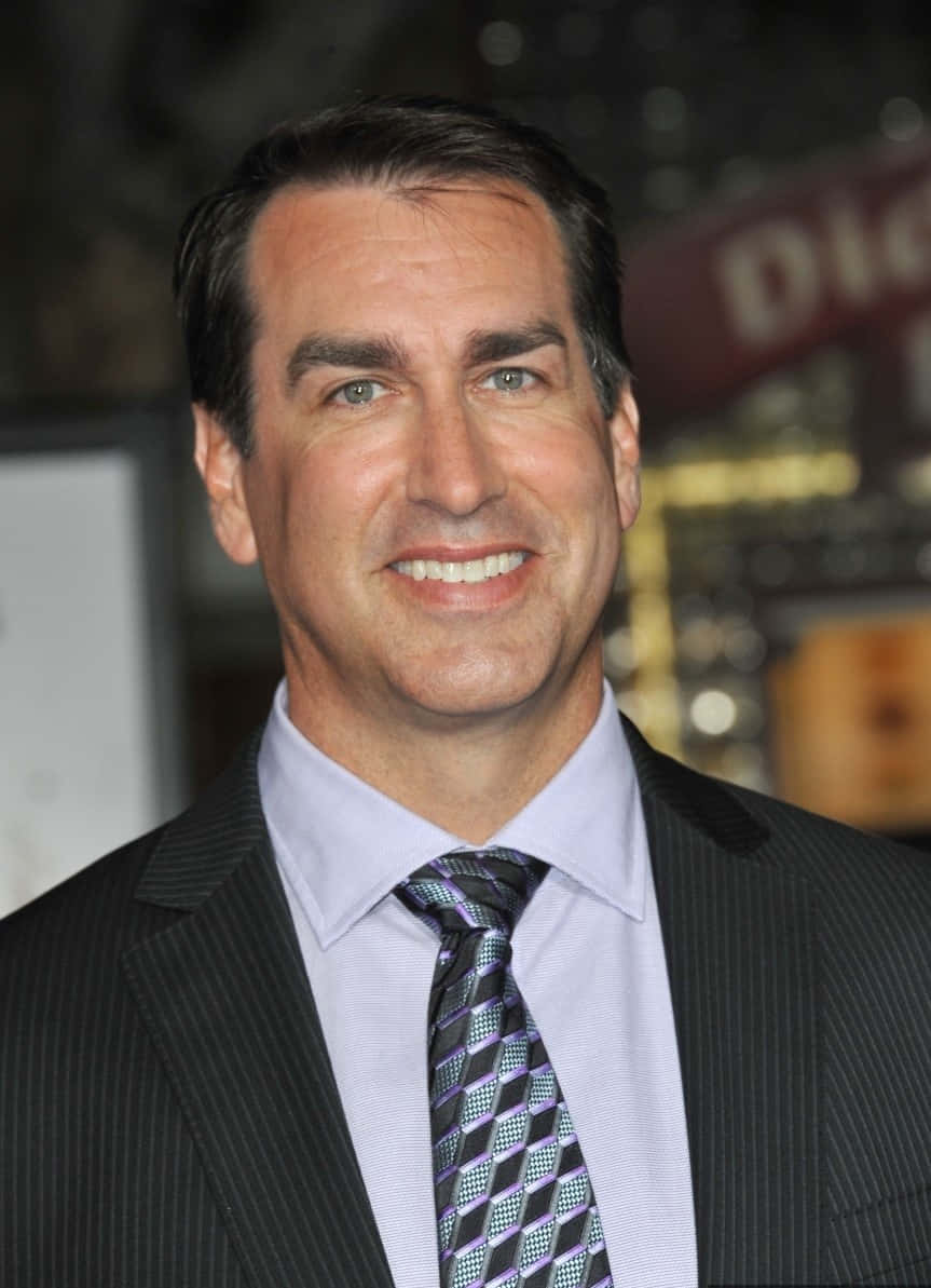 Comedic Charisma - A Close-up Portrait Of Rob Riggle Wallpaper