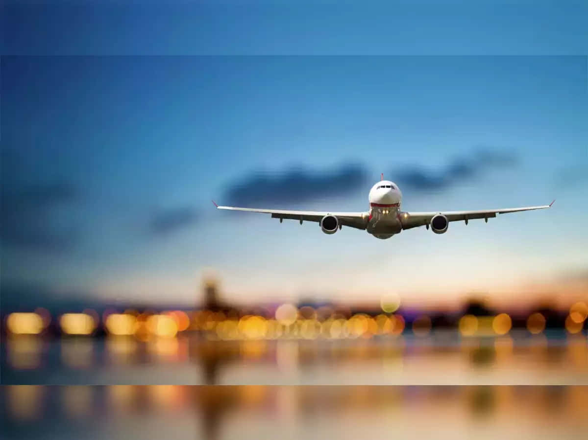 Commercial Airplane Approaching Airport Dusk Wallpaper