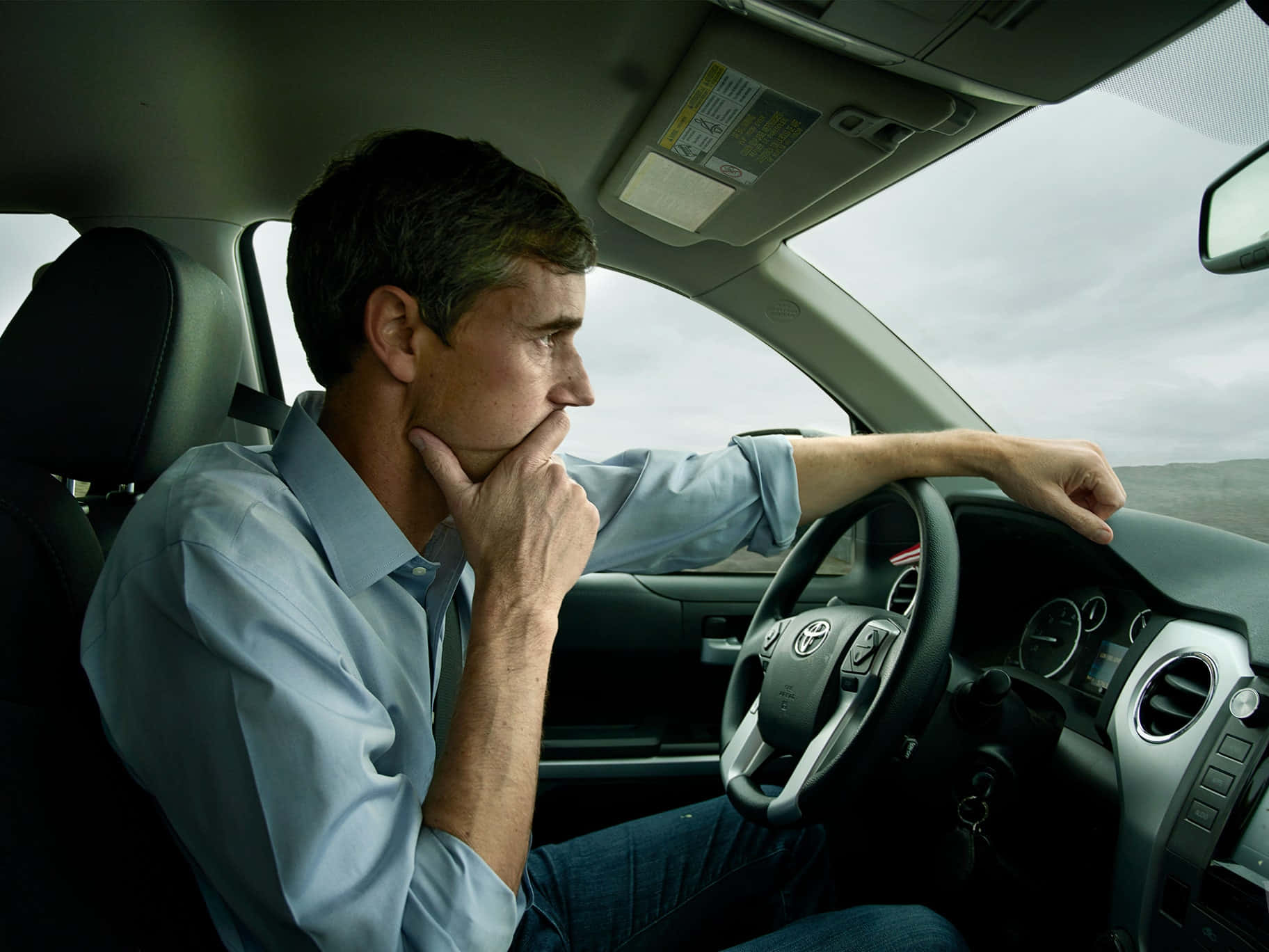 Contemplative Man Driving Wallpaper