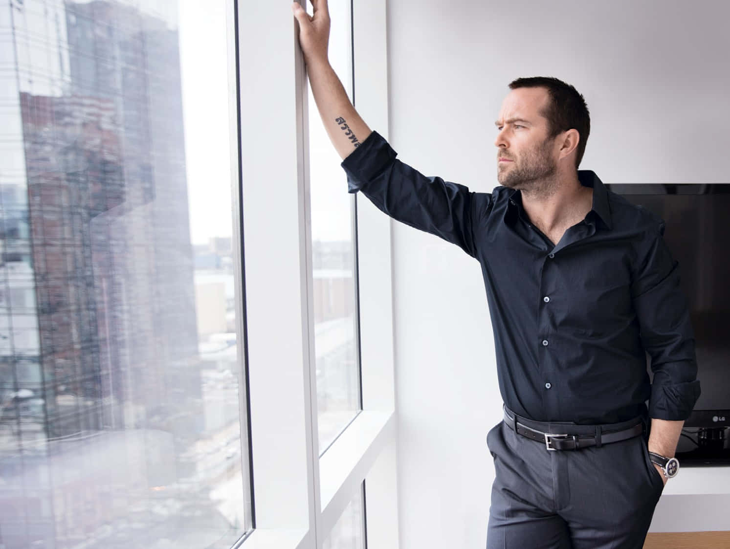 Contemplative Man Looking Out Window Wallpaper