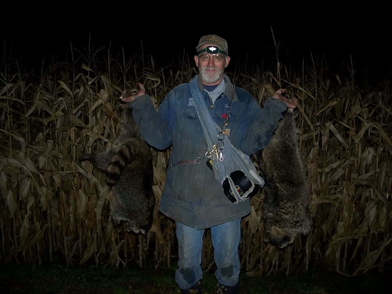 Coon Hunter With Trophies Nighttime Wallpaper