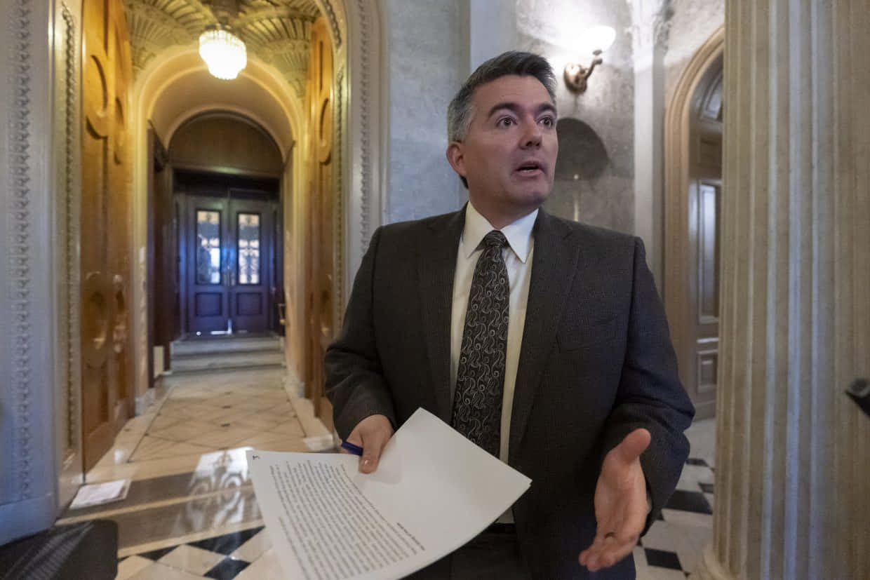 Cory Gardner Speakingin Hallway Wallpaper