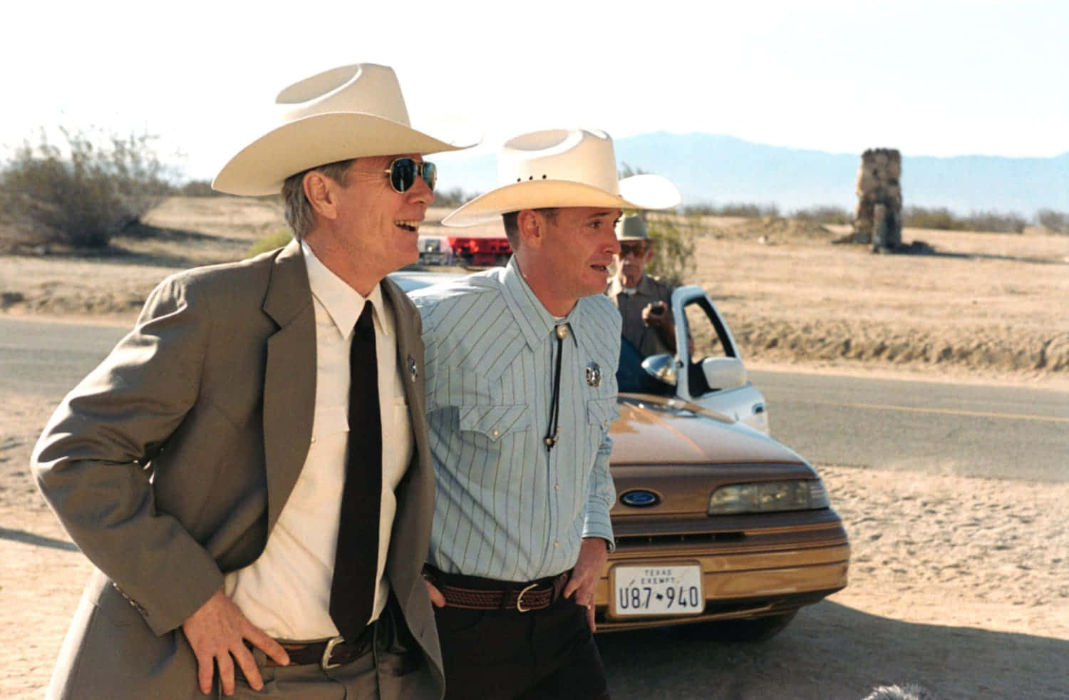 Cowboy Hatted Men Walking Beside Car Wallpaper