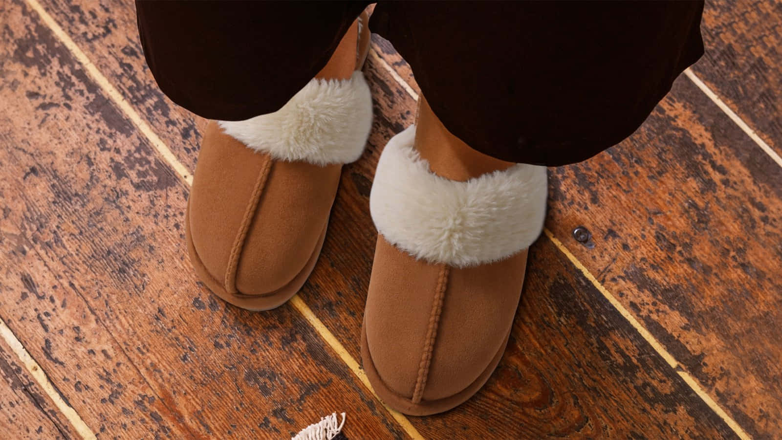 Cozy Brown Slippers Wooden Floor Wallpaper