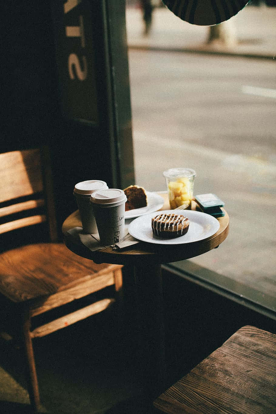 Cozy Coffee Shop Table With Treats Wallpaper