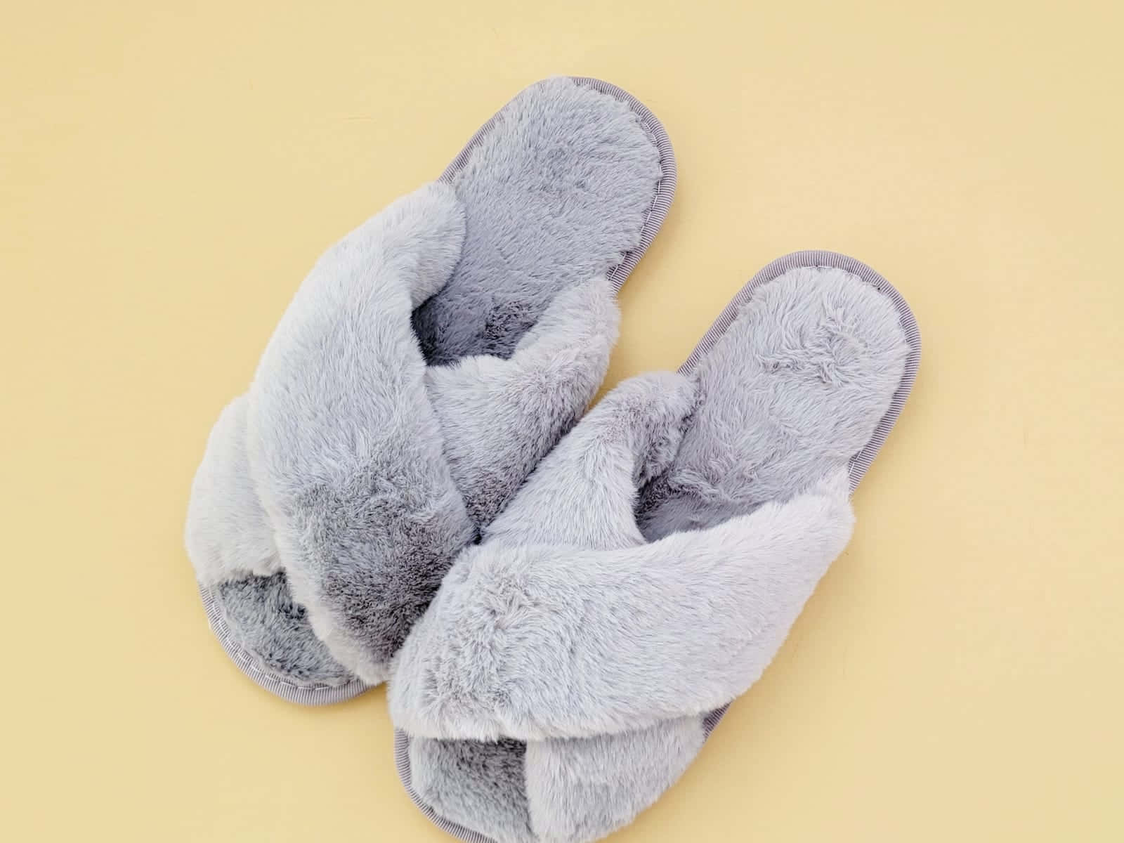 Cozy Gray Furry Slippers Yellow Background.jpg Wallpaper