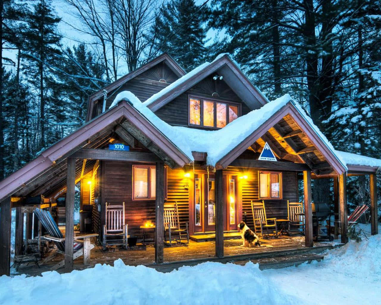 Cozy Winter Cabin Nestled In Snowy Forest Wallpaper