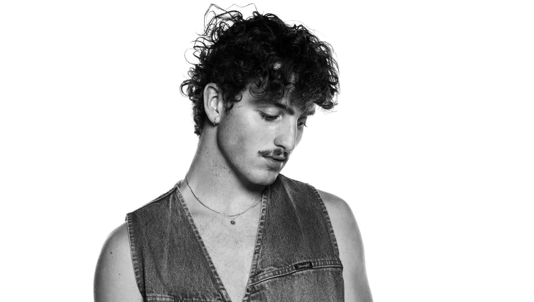 Curly Haired Manin Denim Vest Wallpaper