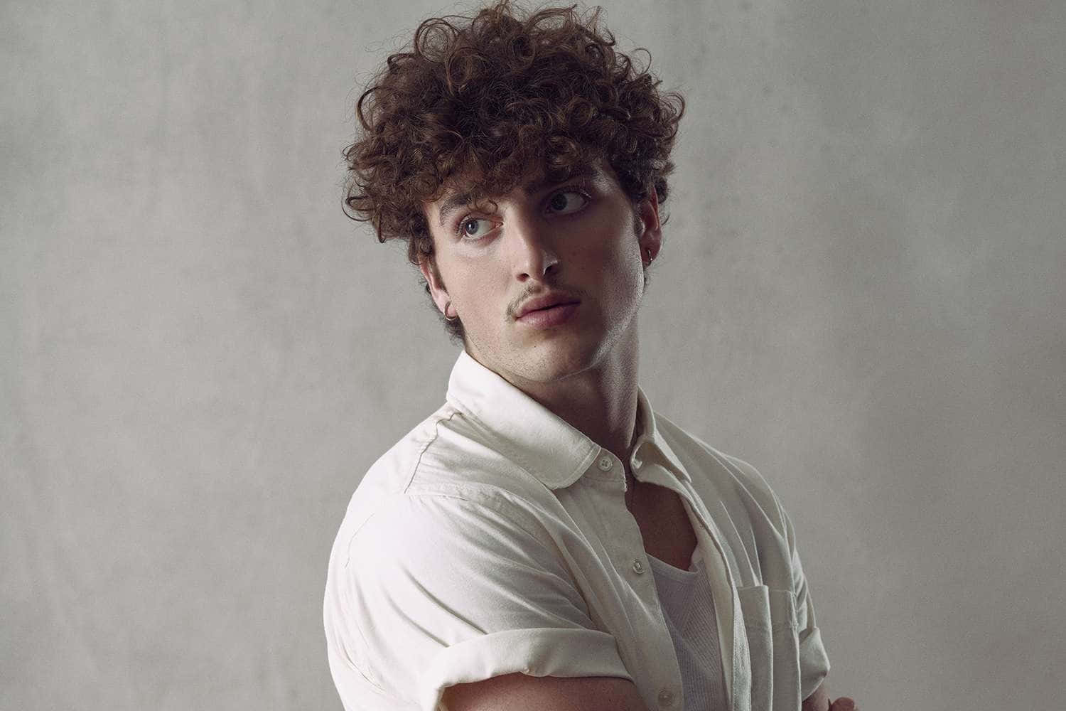 Curly Haired Manin White Shirt Wallpaper