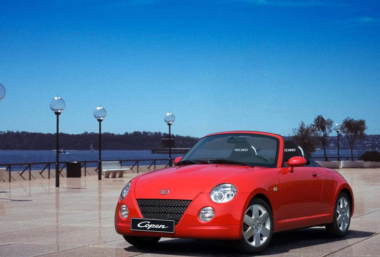 Daihatsu Compact Car On A City Street Wallpaper