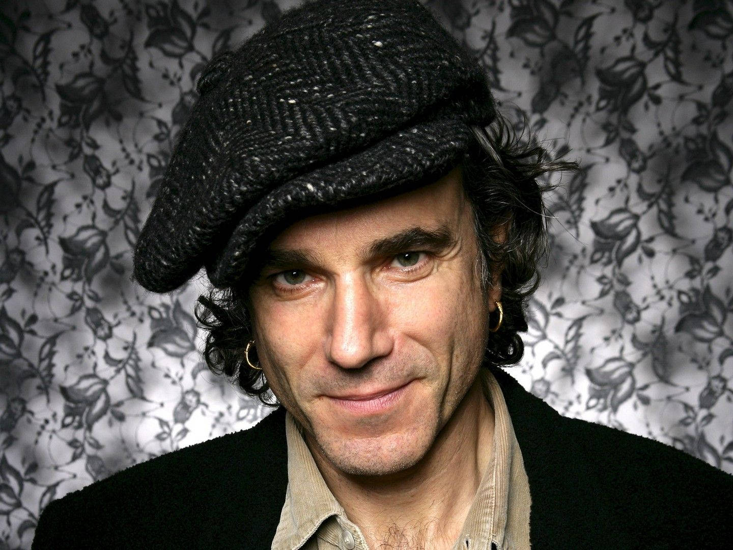 Daniel Day-lewis Captivating Stance Against A Vibrant Floral Background Wallpaper