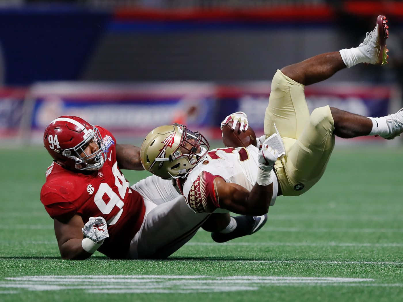 Daron Payne Tackling Opponent During Game Wallpaper