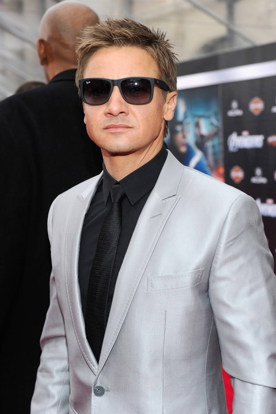 Dashing Hollywood Star Jeremy Renner Dressed In Silver Suit Wallpaper