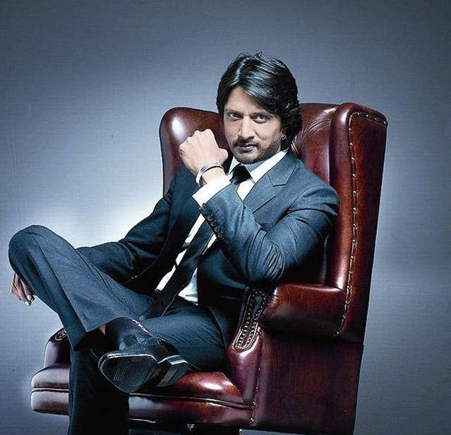 Dashing Sudeep On Maroon Chair Wallpaper