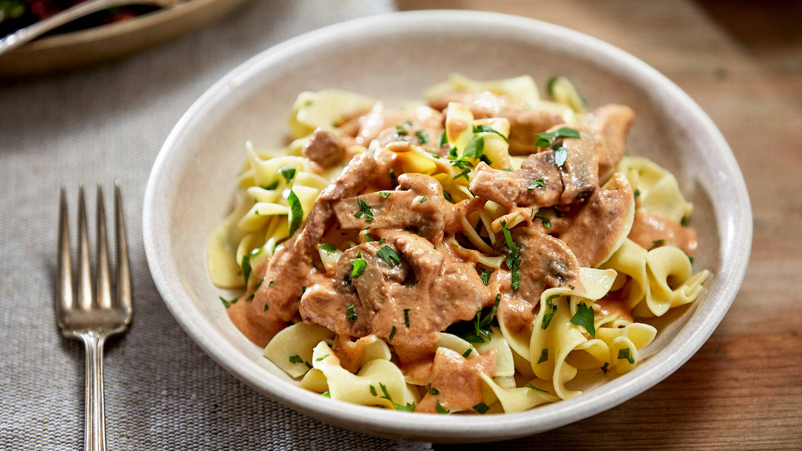 Delectable Beef Stroganoff Served On Pasta Wallpaper