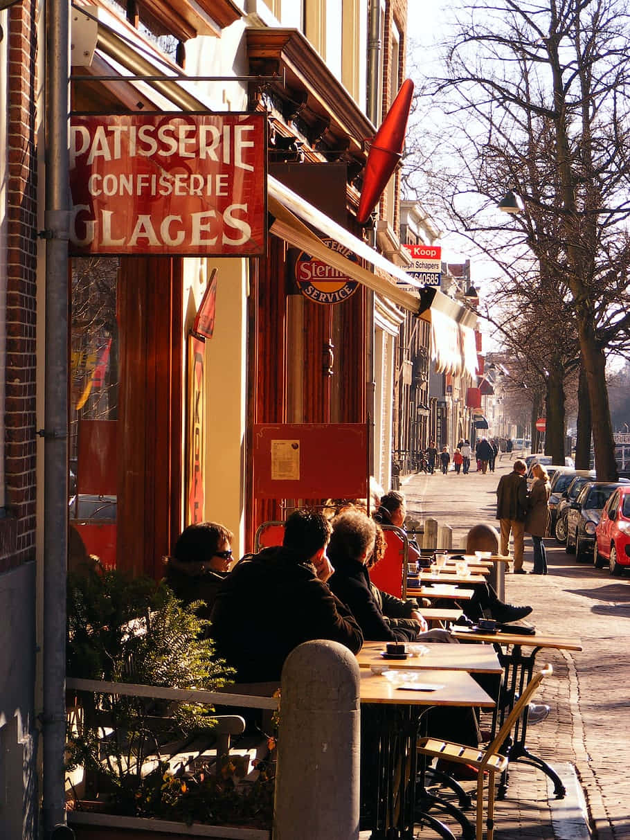 Delft Sidewalk Cafe Patisserie Scene Wallpaper