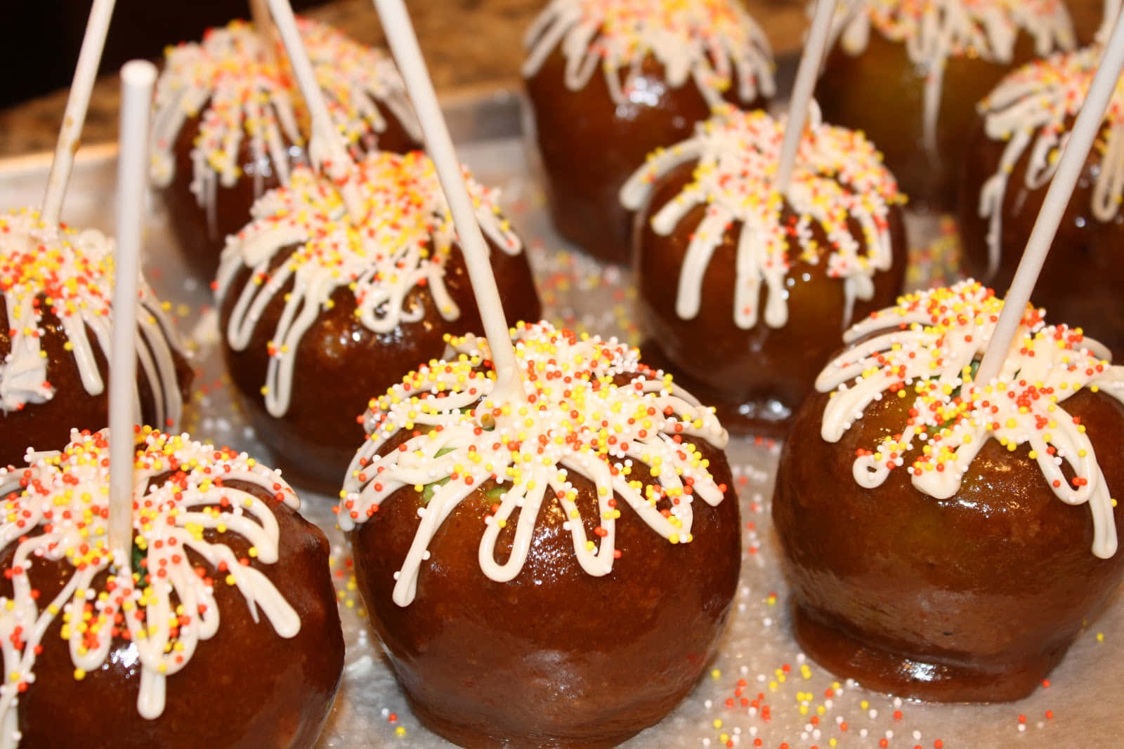 Delicious Caramel Apples On A Rustic Wooden Table Wallpaper