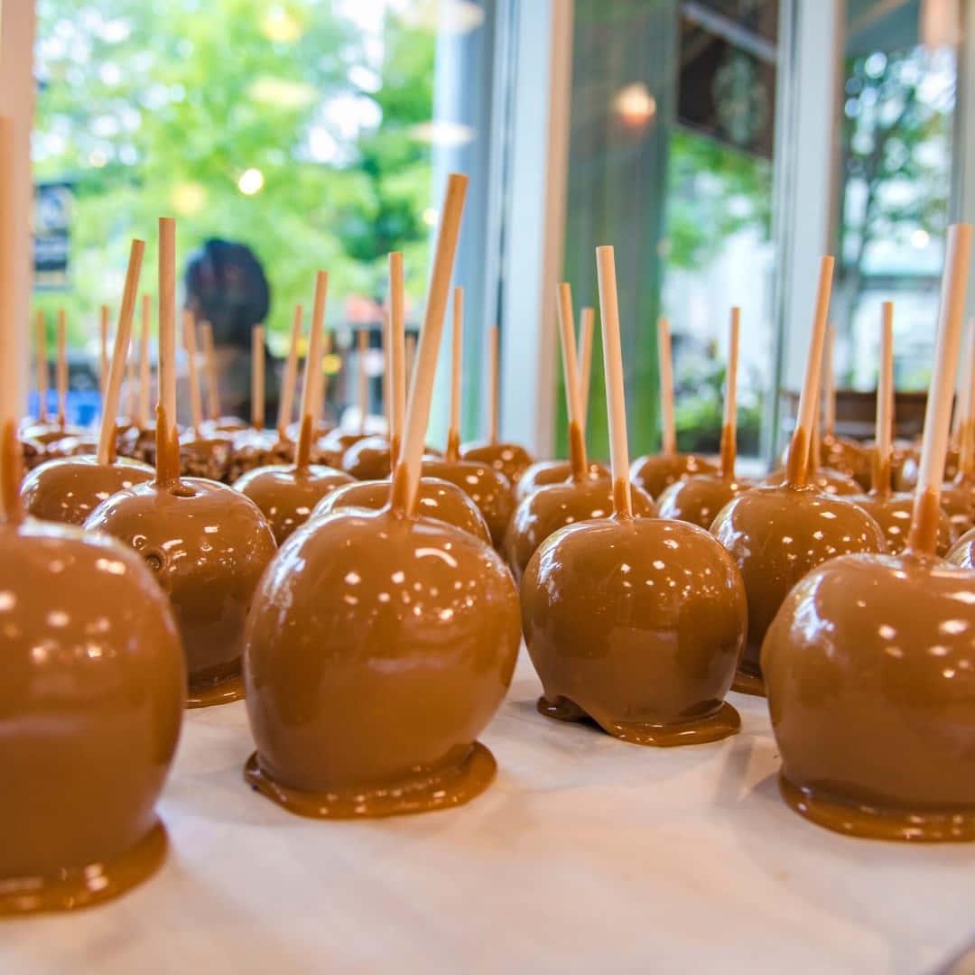 Delicious Caramel Apples With A Variety Of Toppings Wallpaper