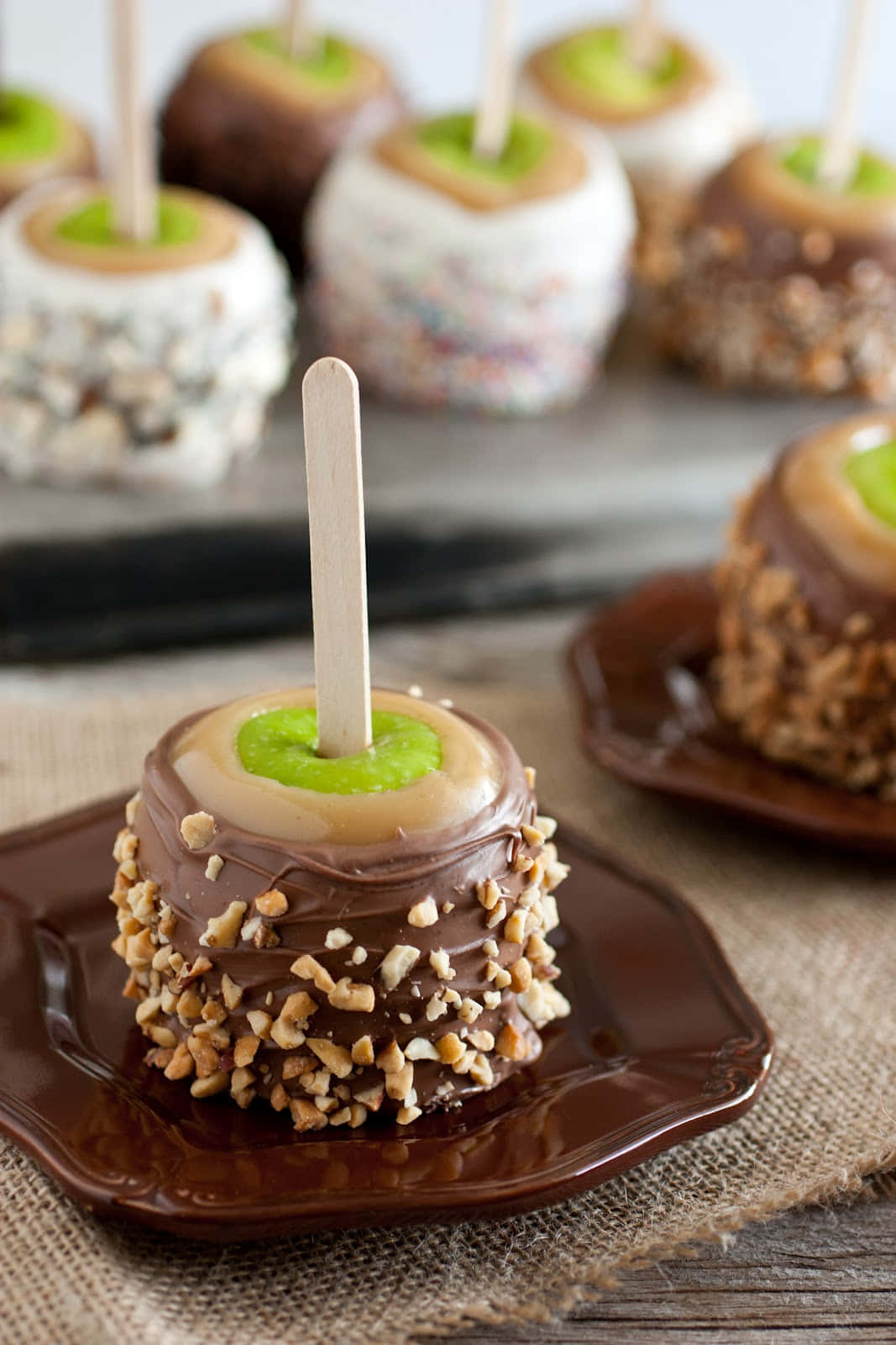 Delicious Caramel Apples With Assorted Toppings Wallpaper