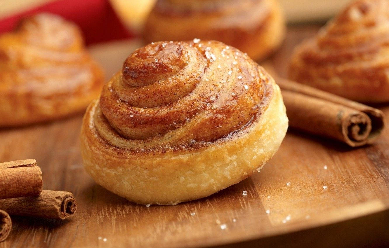 Delicious Cinnamon Bun Topped With Cinnamon Spice Wallpaper