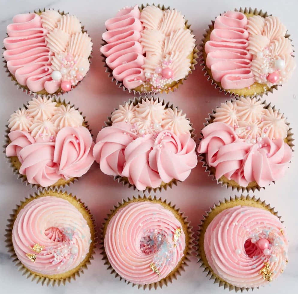 Delicious Pink Cupcakes On White Plate Wallpaper