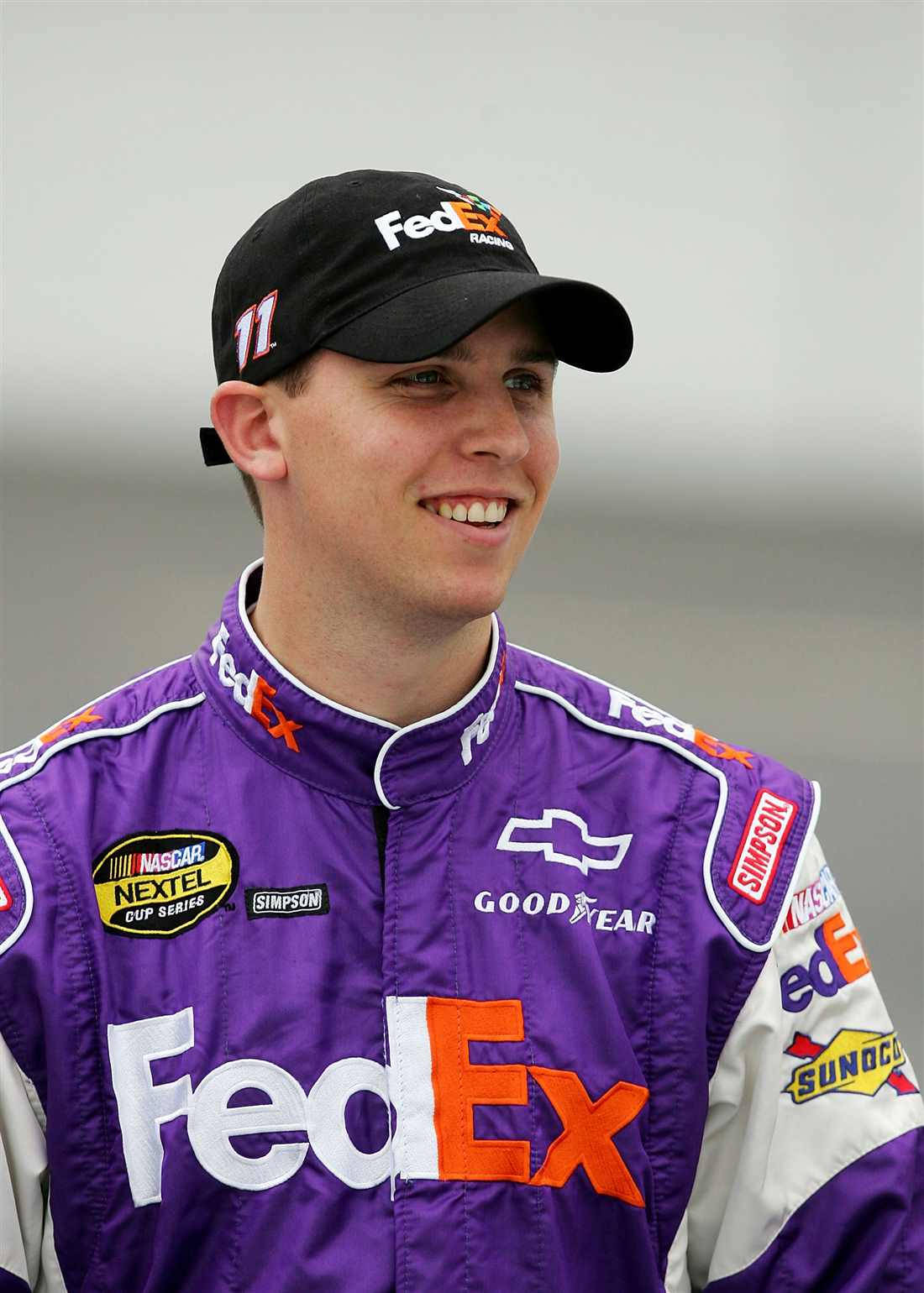 Denny Hamlin In Vibrant Purple Racing Suit Wallpaper