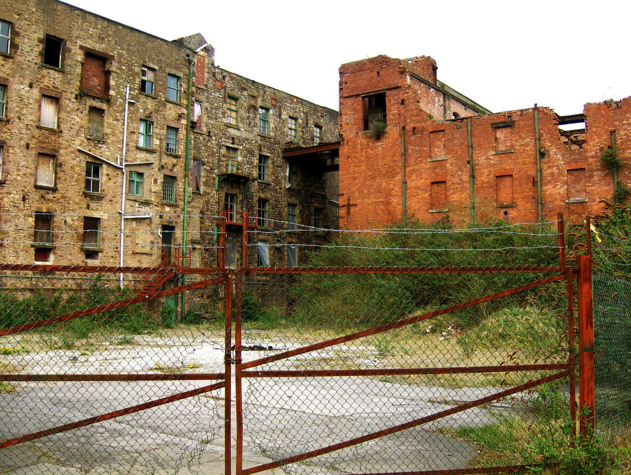 Derelict_ Building_ Behind_ Fence_ Lancaster_ U K Wallpaper