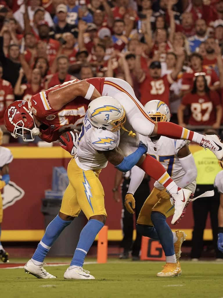 Derwin James Tackling Travis Kelce Wallpaper