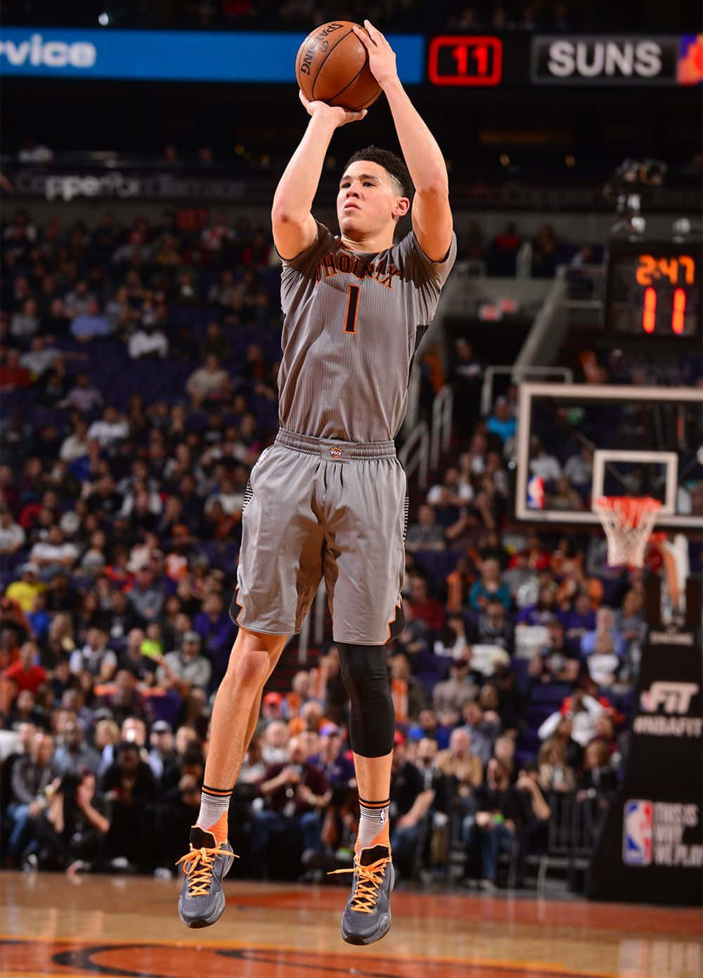 Devin Booker's Face On An Iphone Wallpaper