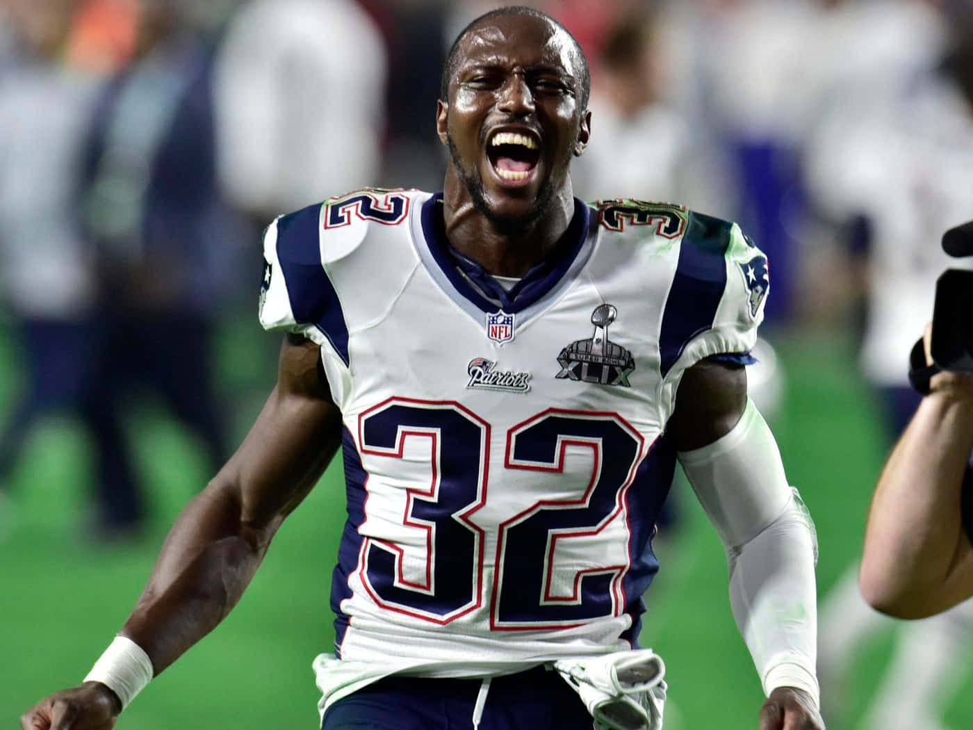 Devin Mccourty In Action During A Football Game Wallpaper