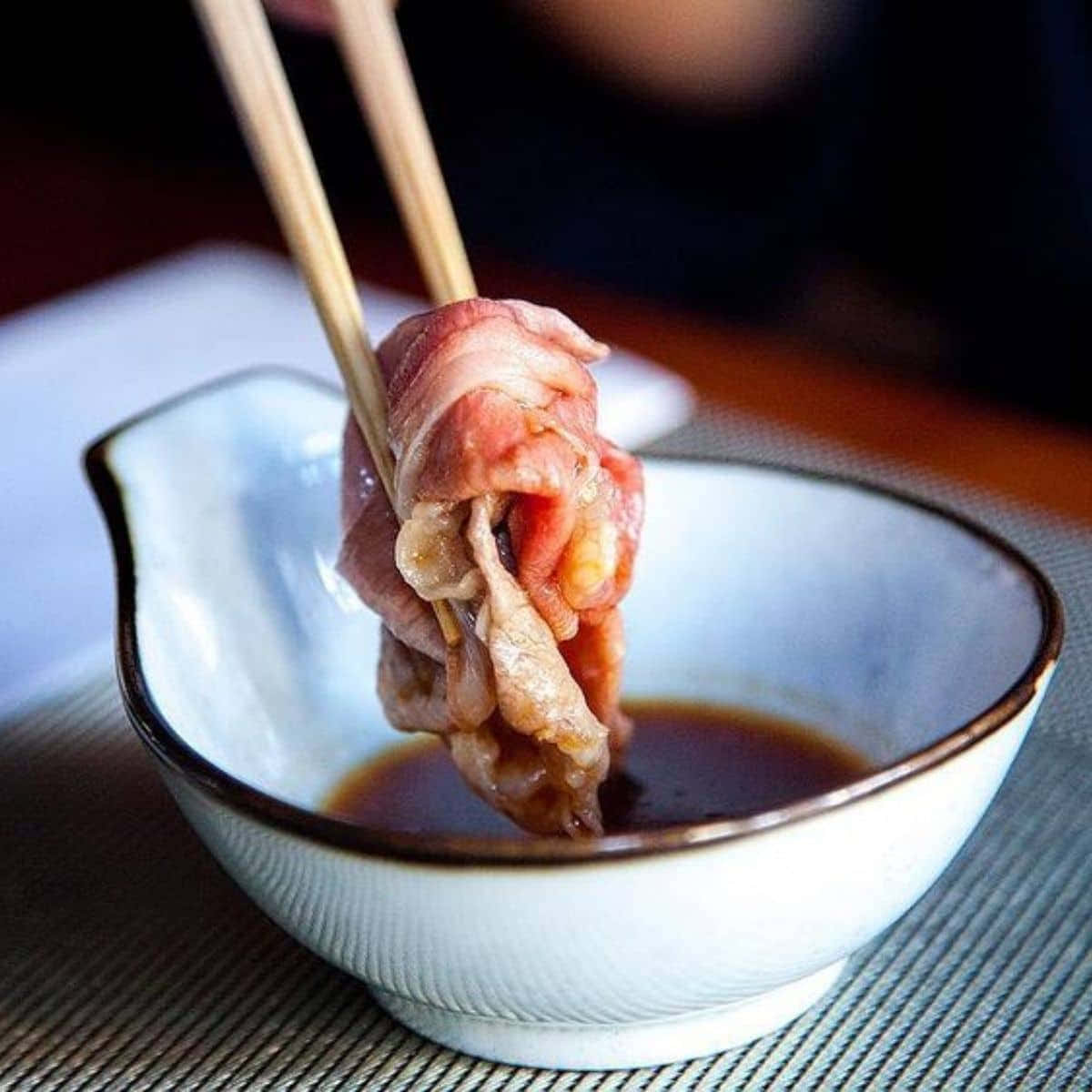 Dipping The Meat In A Shabu-shabu Sauce Wallpaper