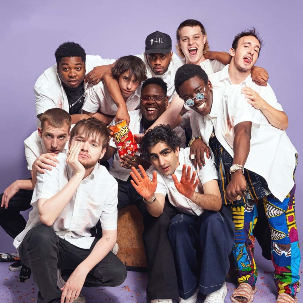 Diverse Group Of Brockhampton Members On A Rooftop Wallpaper