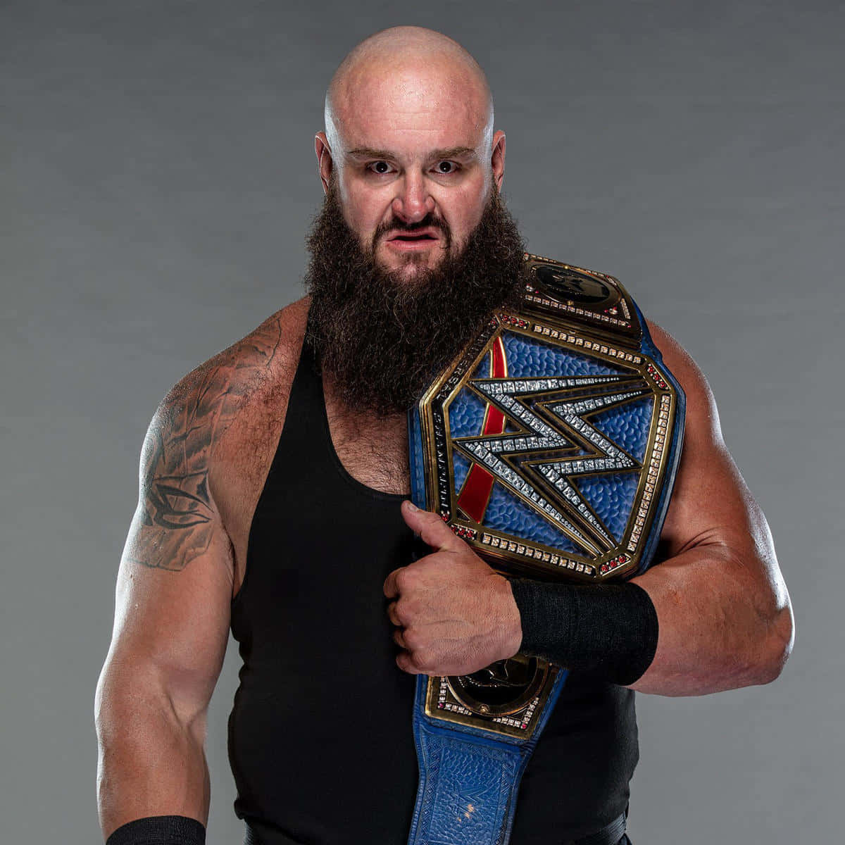 Dominant Force In Wwe, Braun Strowman, Hoisting His Championship Belt Wallpaper