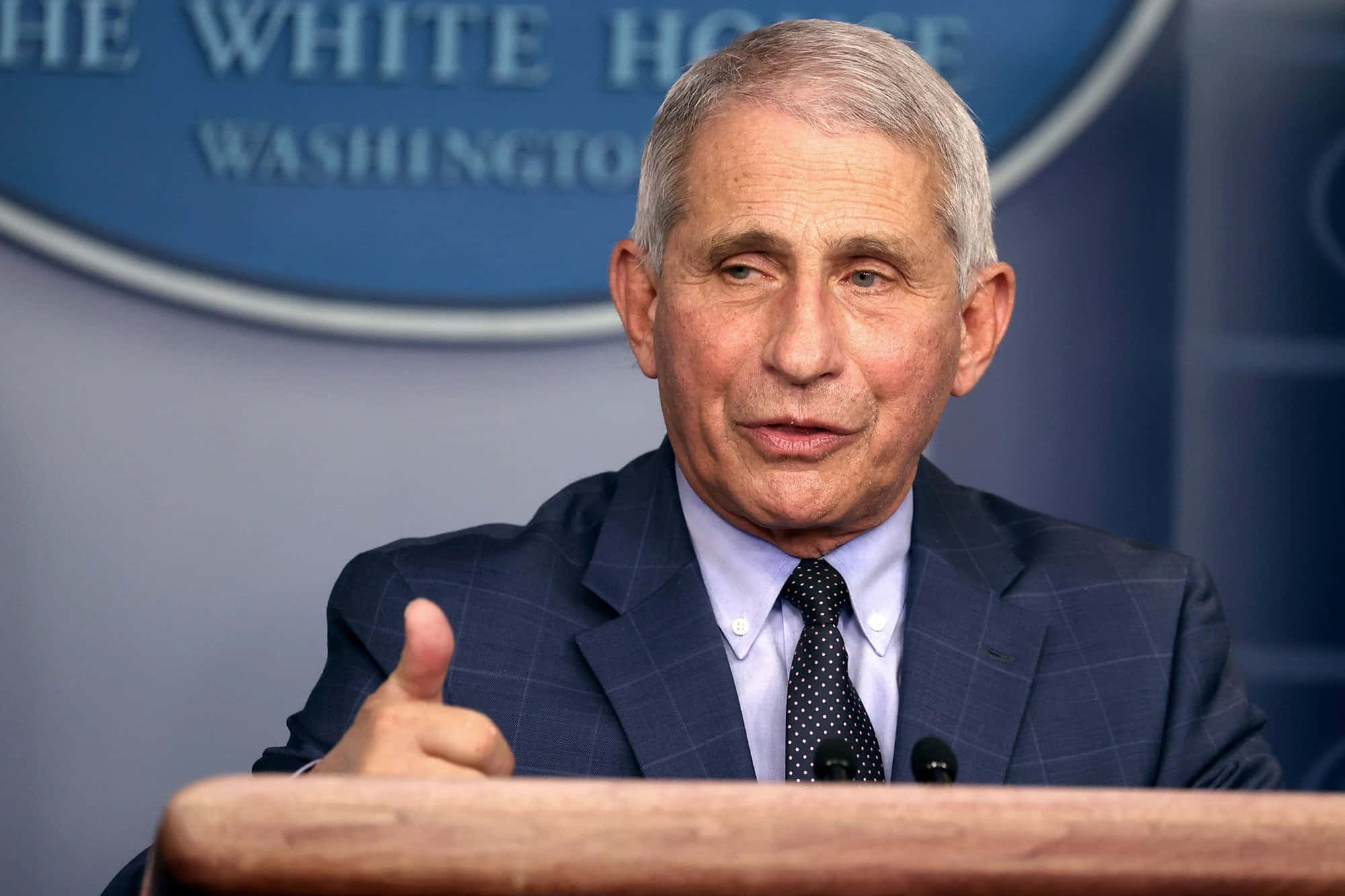 Dr. Anthony Fauci Delivering A Speech At The Covid-19 Pandemic Press Conference Wallpaper