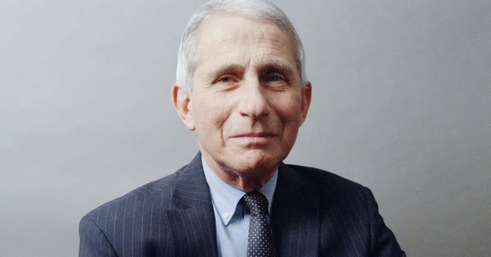 Dr. Anthony Fauci During A Press Conference Wallpaper