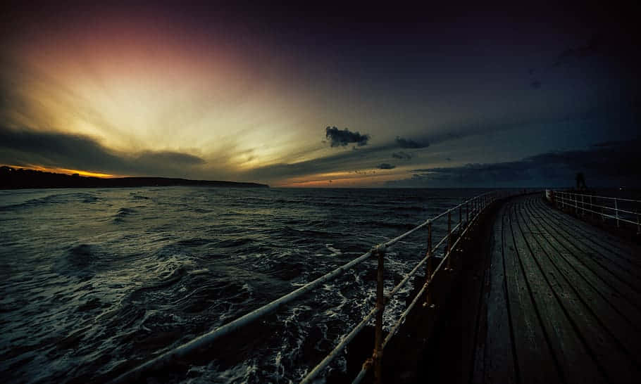 Dramatic Sunset Over Pier Waterfront Wallpaper