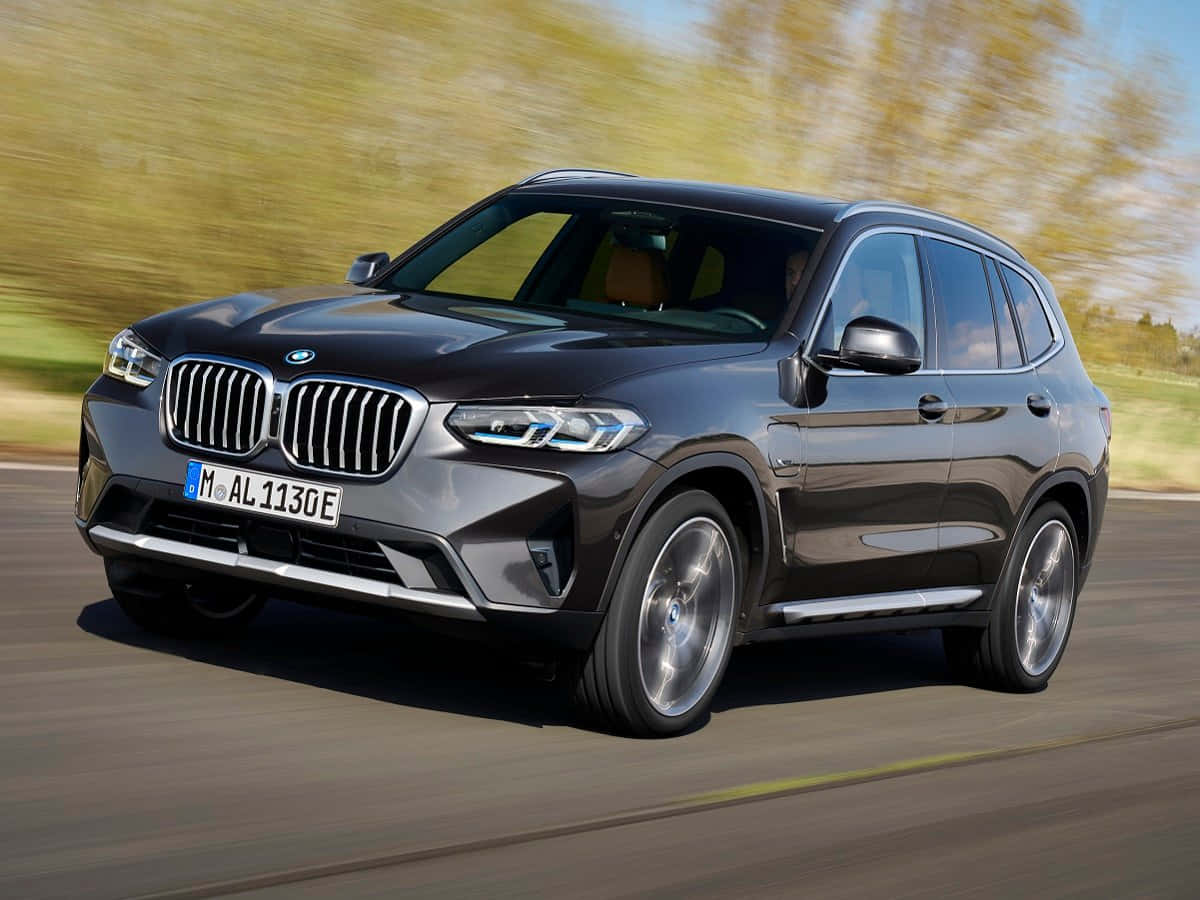 Dynamic And Powerful Bmw X5 On The Road Wallpaper