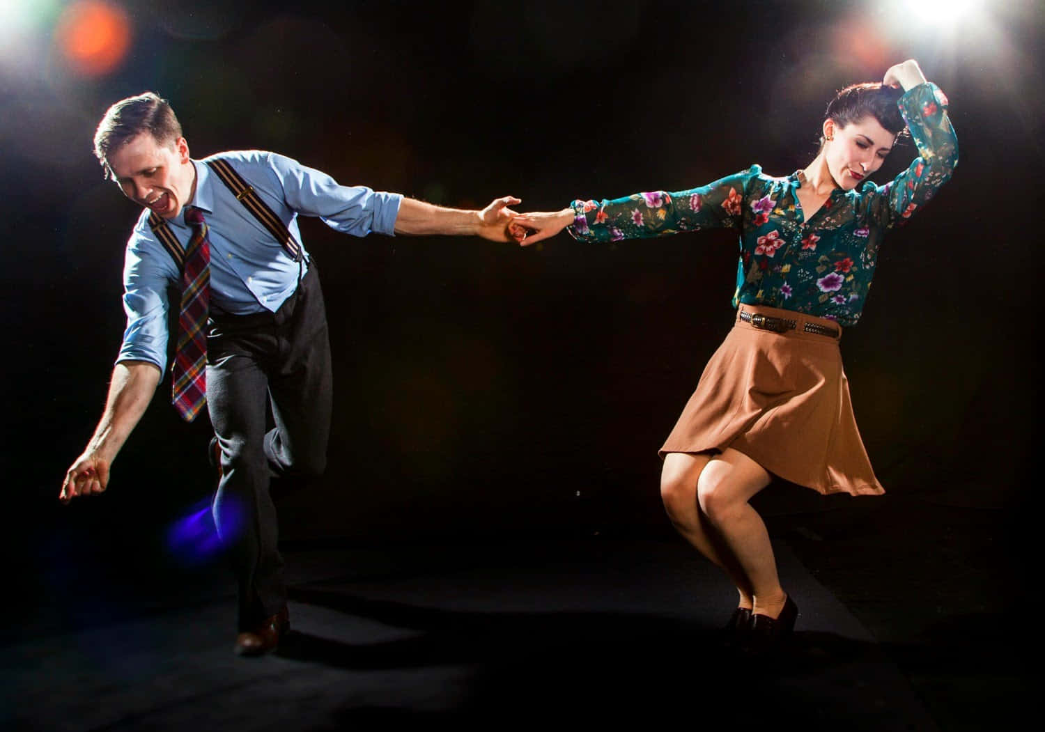 Dynamic Duo Performing Enthralling Swing Dance Wallpaper