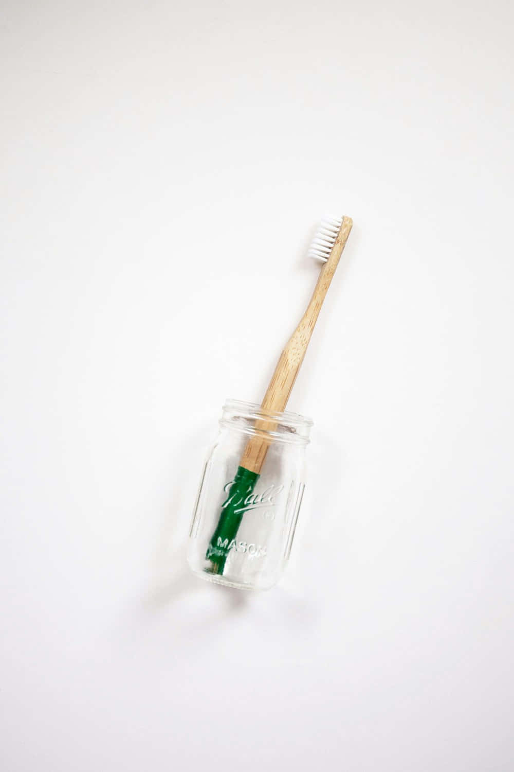 Eco Friendly Toothbrushin Glass Jar Wallpaper