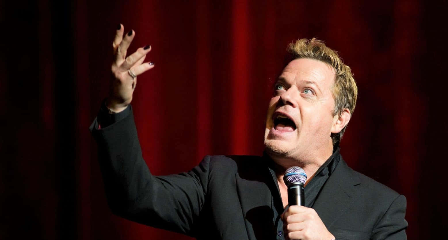 Eddie Izzard Performing Live On Stage Wallpaper