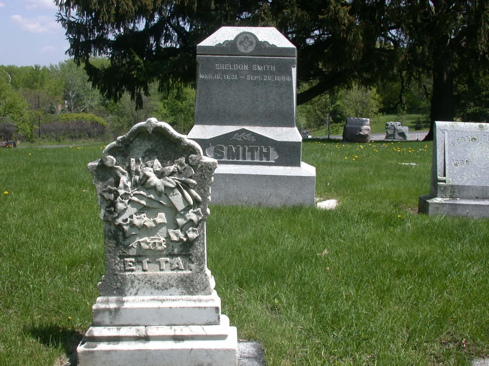 Eerie Gravestone Under A Cloudy Sky Wallpaper