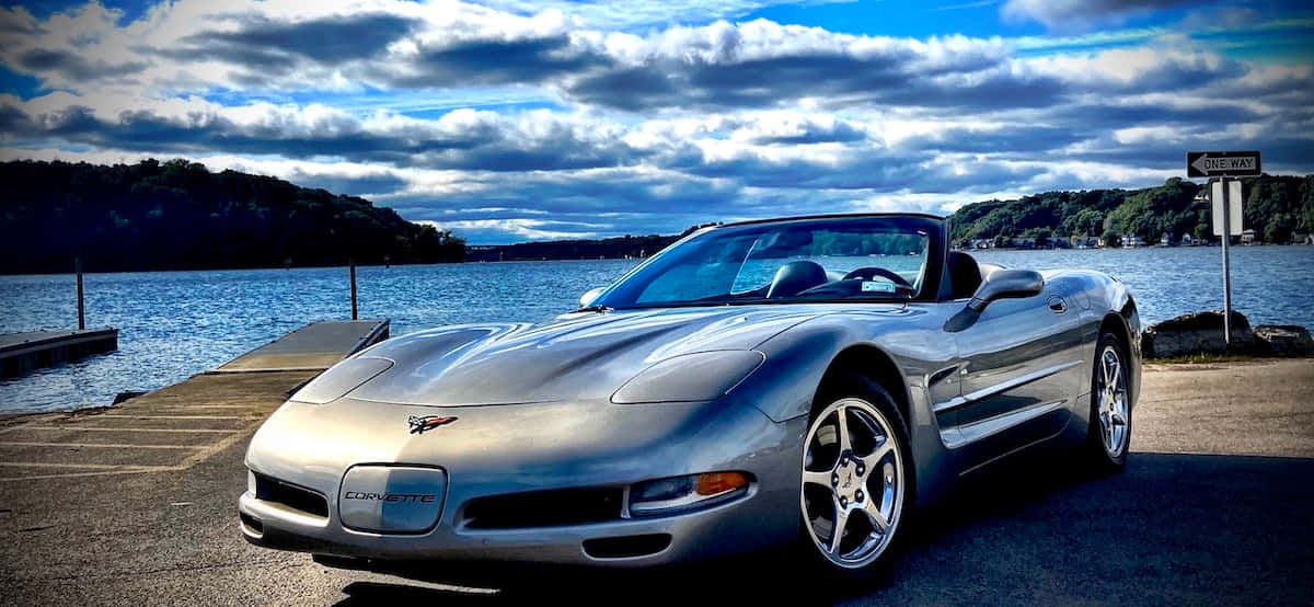 Elegant Chevrolet Corvette C5 Cruising On Highway Wallpaper