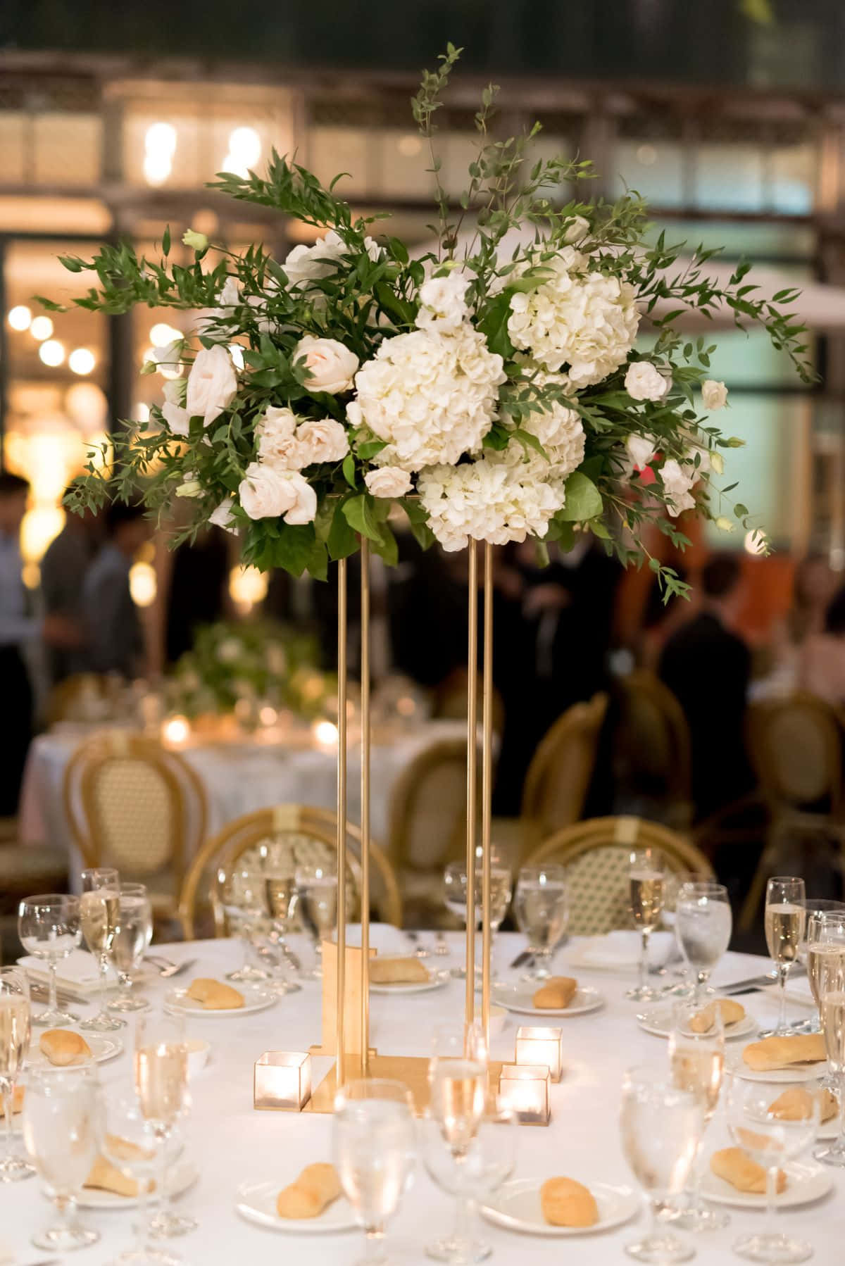 Elegant Floral Centerpiece On A Dining Table Wallpaper